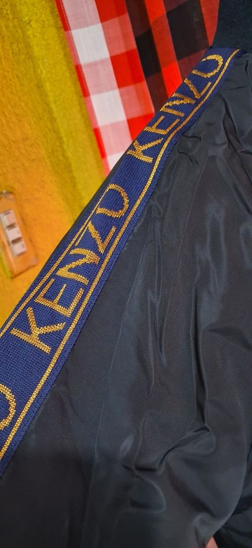 KENZO Paris Black Jacket XXL (Category: Coats, Jackets and Outerwear) located in Manila. Submitted by katkween23 (Listing ID 1468318513, Image 2). Description: - Brand: KENZO Paris - Color: Black with blue and gold patterned sleeve stripes - Size: XXL - Material: 100% Cotton - Origin: Made in Turkey - Details: Features iconic tiger logo tag inside the collar and clean inner care labels - Style: Versatile wardrobe staple, great for daily wear.