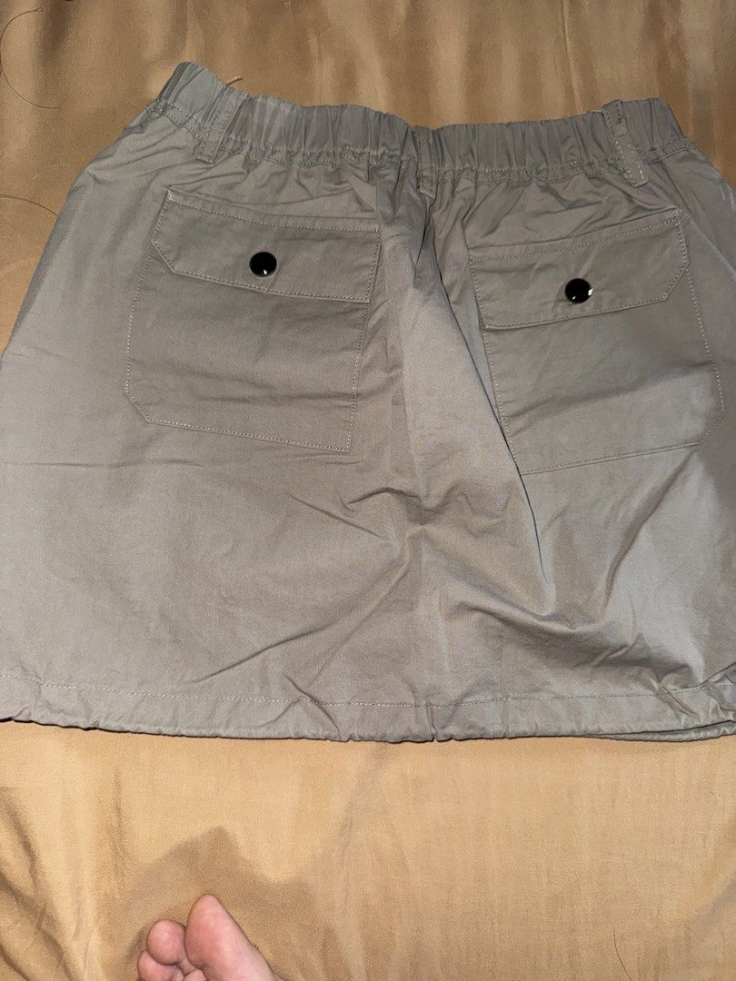 Khaki Utility Cargo Skirt with Drawstring Hem (Category: Skirts) located in Mandaluyong City. Submitted by jeyviee (Listing ID 1468289964, Image 2). Description: - Color: Versatile Khaki - Length: Midi silhouette - Material: Lightweight cotton blend for all-day comfort - Fit: Elastic waistband with an adjustable drawstring hem - Details: Two back flap pockets with secure black button closures - Style: Perfect for casual everyday outfits and stree