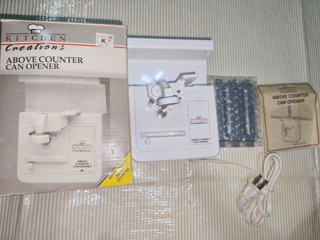 Kitchen Creations Above Counter Can Opener (Category: Cookware & Accessories) located in Manila. Submitted by reascheyss51406 (Listing ID 1468320588, Image 1). Description: - Brand: Kitchen Creations electric can opener in clean white - Space-saving: Mounts easily under cabinets to keep your counters clear - Fully automatic: Effortlessly pierces cans, holds them in place, and includes a handy lid magnet - Easy maintenance: Features a removable cu