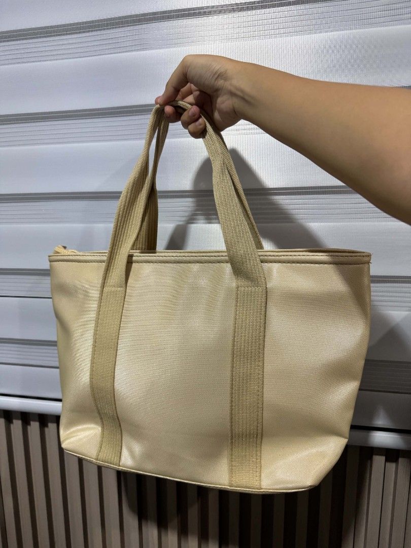 Lacoste Beige Tote Bag (Category: Tote Bags) located in Iloilo. Submitted by frdhbrd (Listing ID 1468387577, Image 2). Description: - Brand: Lacoste - Color: Versatile beige - Material: Durable woven fabric with structured handles - Closure: Secure zippered top - Interior: Clean fabric lining with zippered and slip pockets for easy organization - Condition: Excellent, clean interior - Style: Minimalist everyday carryall NOT FROM UKAY.
