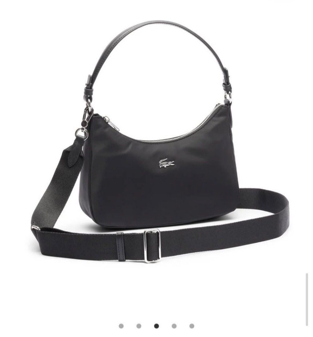 Lacoste Black Nylon Shoulder Bag (Category: Shoulder Bags) located in Polomolok. Submitted by legadad94559 (Listing ID 1468409675, Image 1). Description: - Brand: Lacoste - Color: Classic Black - Material: Lightweight durable nylon with sleek silver hardware - Hardware/Logo: Signature metal crocodile logo on the front - Closure: Secure top zip closure - Straps: Includes a short carry handle and a detachable fabric strap for versatile styling - Co