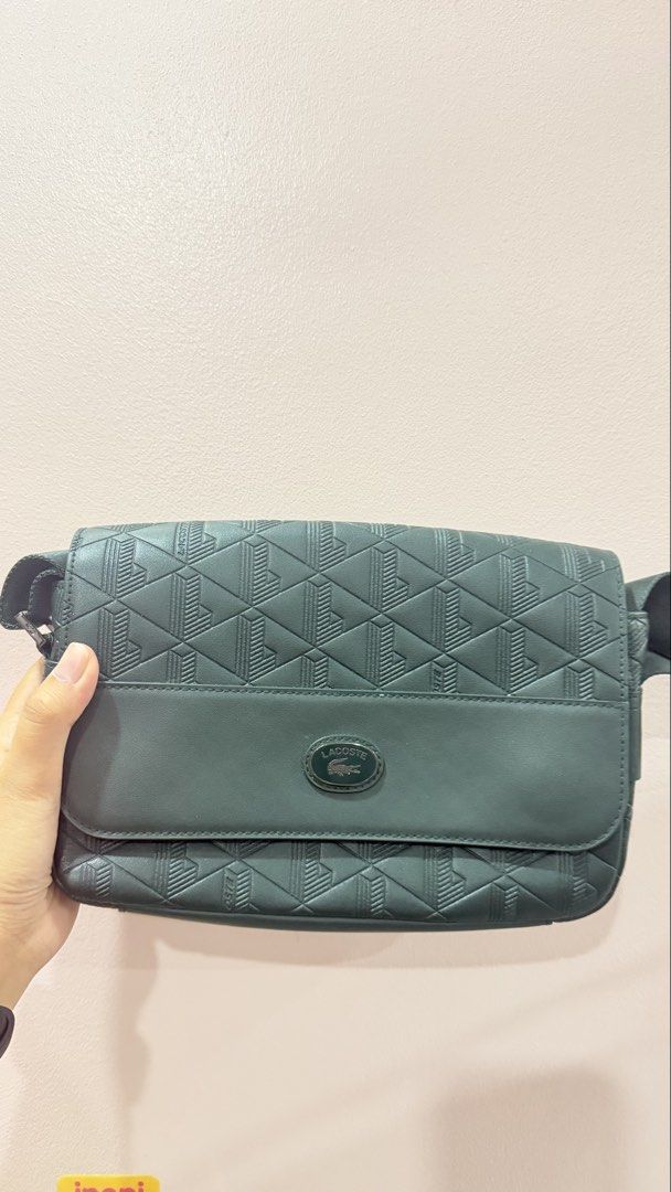 Lacoste Green Geometric Pattern Messenger Crossbody Bag (Category: Sling Bags) located in Manila. Submitted by charlenejdiocales (Listing ID 1468452431, Image 1). Description: - Brand: Lacoste - Color: Dark green - Style: Crossbody / messenger bag - Details: Geometric debossed pattern on flap and front panel - Closure: Secure magnetic snap - Strap: Adjustable webbing strap - Condition: Clean interior, structured shape, great for daily essentials.