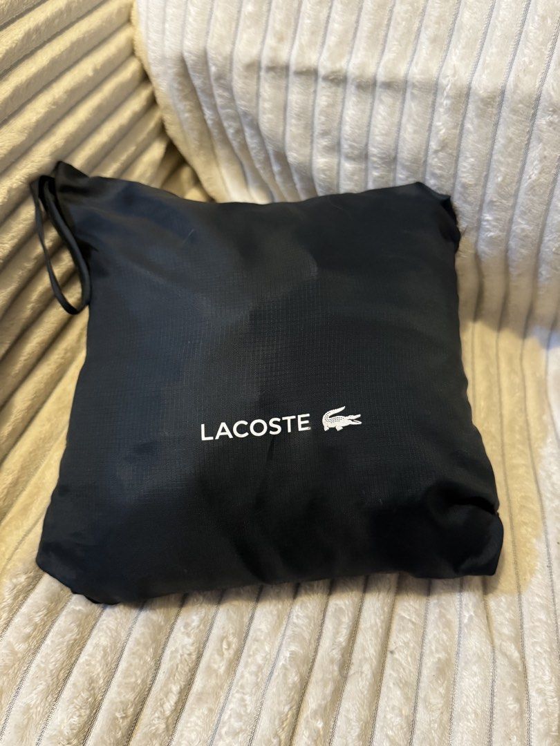 Lacoste Hooded Waterproof Poncho Raincoat (Category: Coats, Jackets and Outerwear) located in Manila. Submitted by jeromepsg12 (Listing ID 1468298402, Image 1). Description: - Brand: Lacoste - Color: Dark green - Condition: Brand new, unused (still in pouch) - Features: Waterproof, half-zip front, hood with drawstrings, and front pocket - Branding: Classic crocodile logo on front, large Lacoste branding on the back - Portability: Lightweight and 