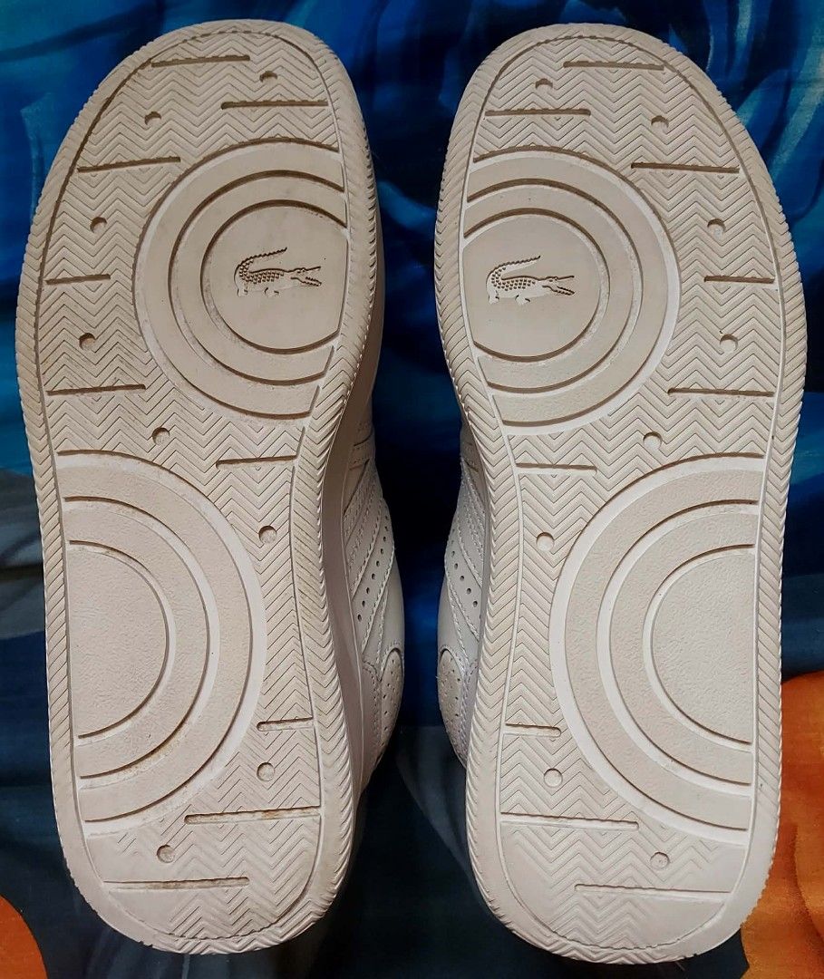Lacoste L005 222 2 SMA White Sneakers (Category: Sneakers) located in Nabunturan. Submitted by kairosas85 (Listing ID 1468330243, Image 2). Description: - Brand: Lacoste L005 Sneakers - Color: White with classic crocodile logo - Size: UK 6 / EUR 39.5 / USA 7 - Features: Clean design, toe perforation, padded collar, and durable rubber outsole - Condition: Great everyday casual pair, includes original paper stuffing.