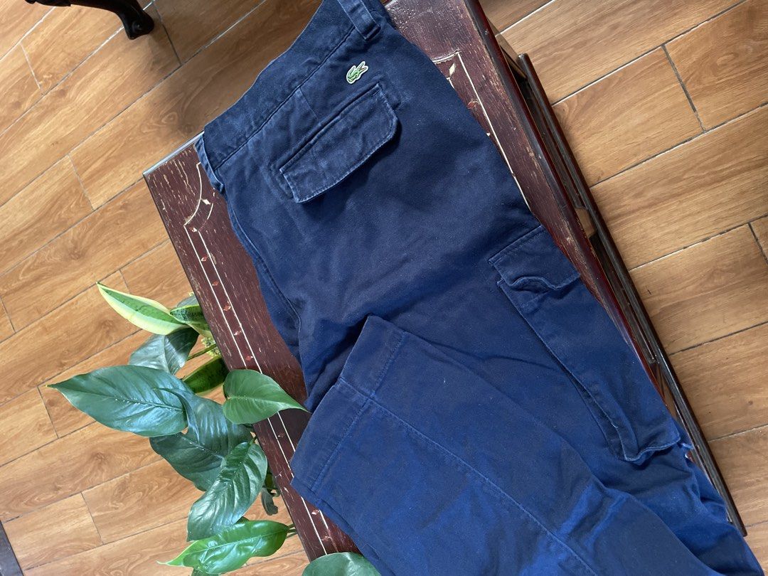 Lacoste Navy Blue Cargo Pants (Category: Joggers) located in Manila. Submitted by barrybalenshagga (Listing ID 1468355042, Image 3). Description: size 36-38 - Brand: Lacoste - Color: Navy Blue - Material: Durable, high-quality cotton - Fit: Classic straight leg cut - Features: Practical side cargo pockets and back pockets with button flaps - Branding: Iconic embroidered green crocodile logo on the back right pocket - Style: Versatile and comforta