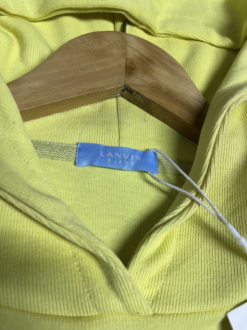 Lanvin Blanc Yellow Hoodie Size S (Category: Hoodies) located in Caloocan City. Submitted by flipthatcloths8600 (Listing ID 1468416098, Image 3). Description: - Brand: Lanvin Blanc - Color: Bright yellow with white fuzzy logo embroidery and contrast tan hem - Size: S (tag attached) - Condition: Brand new, unworn, pristine fabric - Inclusions: Original store tags still on string - Features: Adjustable hood, long sleeves, and ribbed cuffs.