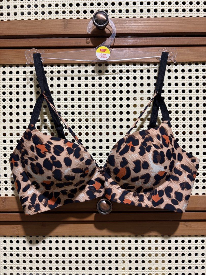 Leopard Print Bra Size 34/75B (Category: Undergarments & Loungewear) located in Pasig City. Submitted by jenfiles (Listing ID 1468439490, Image 1). Description: - Size: 34/75B - Design: Bold leopard print in shades of brown, black, and orange - Straps: Black adjustable straps featuring trendy multi-way front detailing - Support: Underwire cups for a flattering lift and shape - Closure: Classic black fabric back band with hook-and-eye closure.