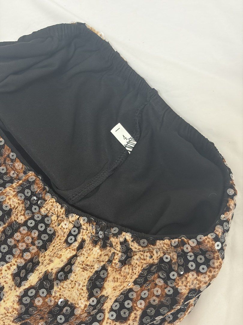 Leopard Print Sequin Mini Skirt Halloween (Category: Skirts) located in Las Pinas. Submitted by thriftedfinds_ (Listing ID 1468419542, Image 2). Description: - Size: L (fits M-semi-Large) garterized skirt with shorts inside - Material: Eye-catching sequins in a fierce leopard print, fully lined with soft black fabric - Fit: Easy pull-on style with a comfortable elastic waistband - Style: Ultimate statement piece for parties, clubs, and night outs