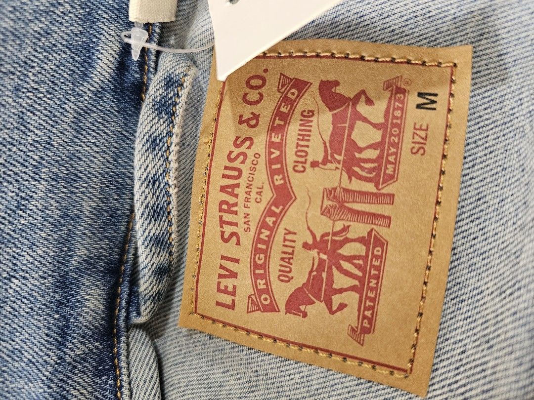 Levi's Original Trucker Jacket. (Category: Coats, Jackets and Outerwear) located in Baguio. Submitted by kayeonlineshop (Listing ID 1468349756, Image 2). Description: classic light-wash blue denim jacket featuring a button-front closure, dual chest flap pockets, and a signature red Levi's tab.
