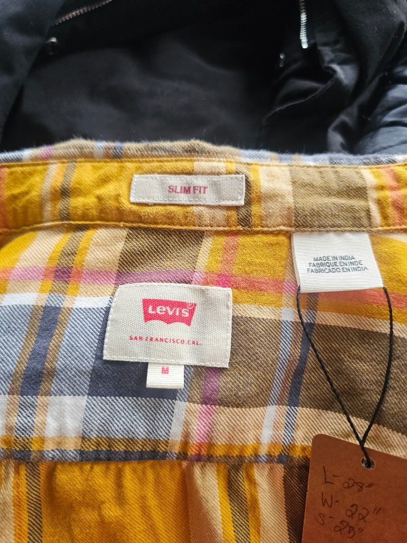 Levi's yellow and grey plaid checked long-sleeve (Category: Formal Shirts) located in Baguio. Submitted by kayeonlineshop (Listing ID 1468298031, Image 3). Description: long-sleeve button-up plaid shirt featuring a bold mustard yellow and dark grey/black checked pattern accented with thin white and red lines. It has a classic casual collar, a single buttoned chest pocket with the iconic red Levi's logo tab, and a regular fit structure..