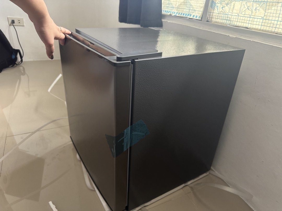LG Mini Fridge Single Door Refrigerator Dark Grey (Category: Refrigerators and Freezers) located in Mandaluyong City. Submitted by almachristinecruz8160 (Listing ID 1468312091, Image 1). Description: - Brand: LG Compact Mini Fridge - Color: Sleek Dark Grey Finish - Condition: Brand new, never plugged in, still has original protective tape, foam base, and strapping - Features: Single door setup with a small built-in top freezer compartment - Inter