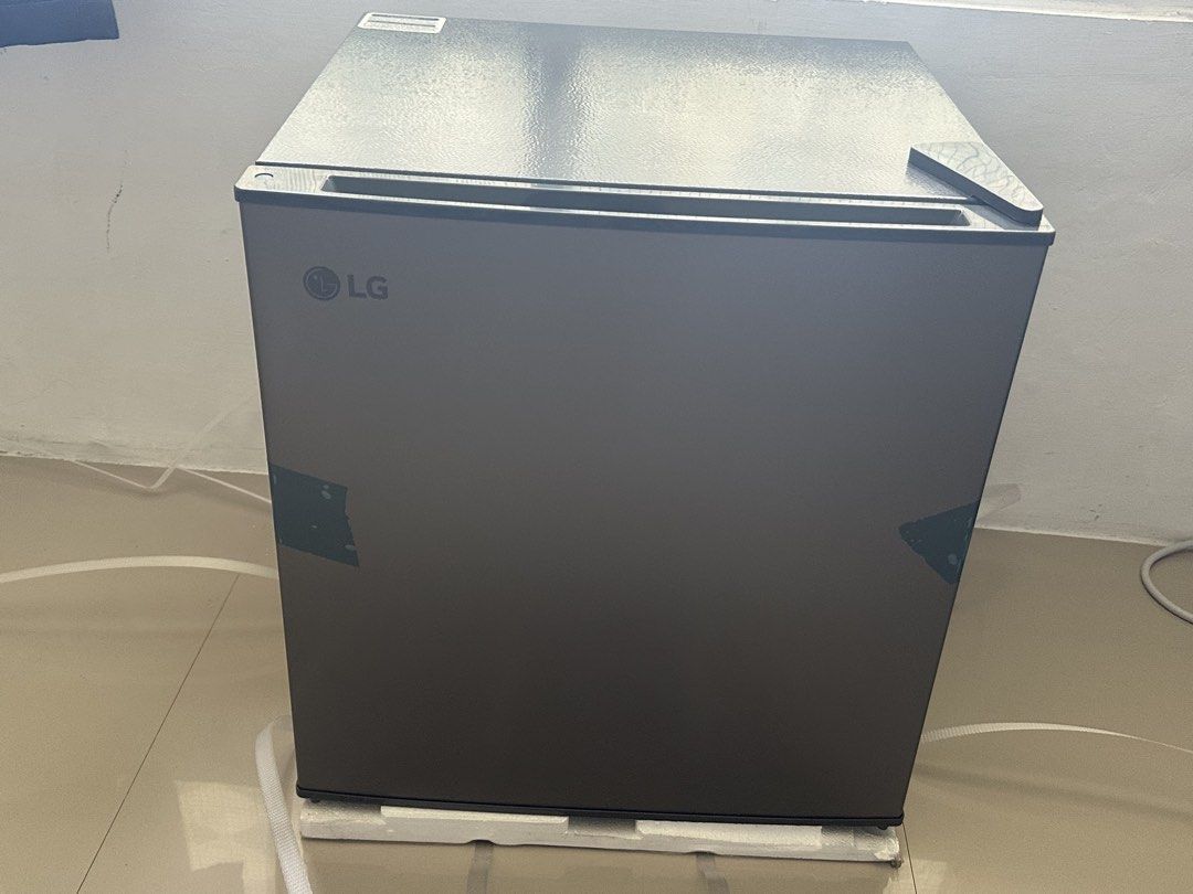 LG Mini Fridge Single Door Refrigerator Dark Grey (Category: Refrigerators and Freezers) located in Mandaluyong City. Submitted by almachristinecruz8160 (Listing ID 1468312091, Image 3). Description: - Brand: LG Compact Mini Fridge - Color: Sleek Dark Grey Finish - Condition: Brand new, never plugged in, still has original protective tape, foam base, and strapping - Features: Single door setup with a small built-in top freezer compartment - Inter