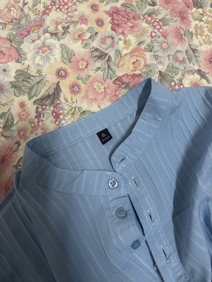 Light blue vertical striped button-up short sleeve shirt (Category: Formal Shirts) located in Manila. Submitted by urthrifthany (Listing ID 1468442145, Image 2). Description: - Color & Pattern: Light blue with stylish vertical stripes - Collar: Mandarin collar with 4 front buttons - Fit & Size: Relaxed fit, Size XL (175/92A) - Material: Smooth and comfortable fabric - Styling: Perfect for everyday casual wear with denim or shorts .