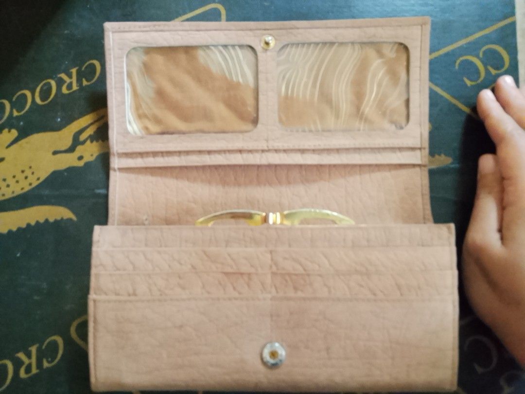 Light Brown Long Wallet with Compartments (Category: Wallets & Card holders) located in Manila. Submitted by amiarnajea96023 (Listing ID 1468329314, Image 2). Description: - Color & Material: Light brown with a stylish textured finish - Closure: Secure front flap with button snap - Interior: Multiple card slots, photo ID windows, and accordion-style compartments - Storage: Convenient zippered pocket for coins - Hardware: Elegant gold tone details