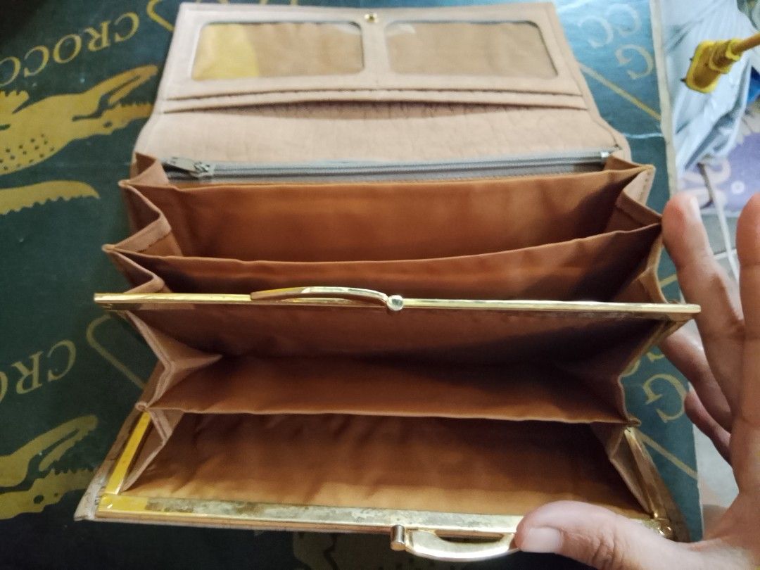 Light Brown Long Wallet with Compartments (Category: Wallets & Card holders) located in Manila. Submitted by amiarnajea96023 (Listing ID 1468329314, Image 3). Description: - Color & Material: Light brown with a stylish textured finish - Closure: Secure front flap with button snap - Interior: Multiple card slots, photo ID windows, and accordion-style compartments - Storage: Convenient zippered pocket for coins - Hardware: Elegant gold tone details