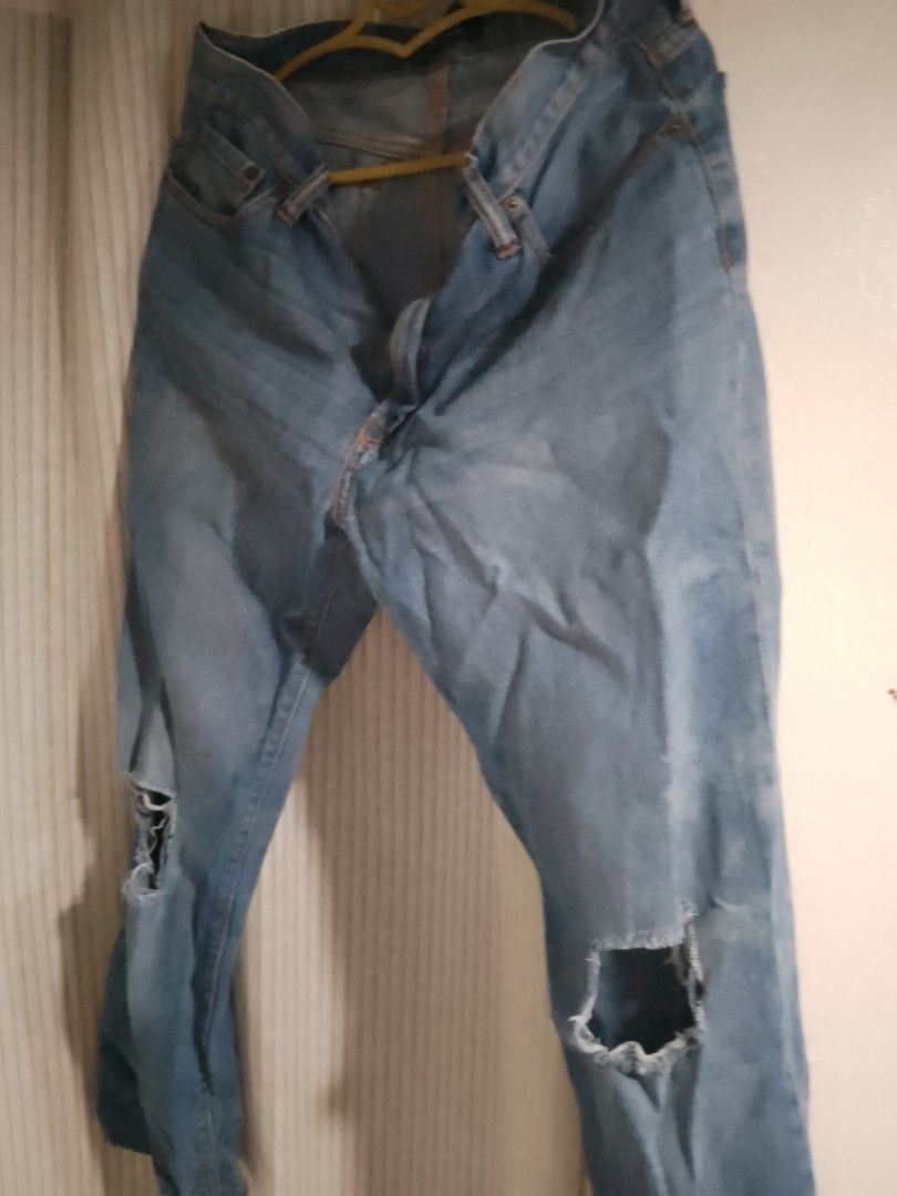 Light wash distressed ripped denim jeans (Category: Jeans) located in Manila. Submitted by warmtiger.a2c491 (Listing ID 1468360796, Image 2). Description: - Style: Casual light wash blue denim jeans with trendy ripped knees - Fit & Closure: Classic button and zip fly with convenient belt loops - Details: Worn-in fading throughout for an effortless vintage vibe - Pockets: Functional pockets on both the front and back - Condition: Clean fabric, no 