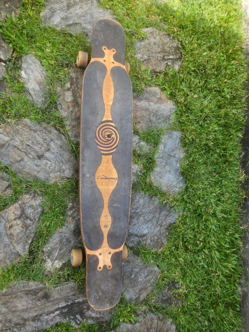 Loaded Bhangra Longboard (Category: Skates, Rollerblades & Scooters) located in Manila. Submitted by declutterhopper (Listing ID 1468306002, Image 1). Description: - Loaded Bhangra longboard deck with custom bottom graphics - Spiral pattern grip tape on top - Equipped with black trucks and yellowish-brown wheels - Shows minor scuffs and wear on edges from normal riding - Fully assembled and ready to use -Paris trucks.