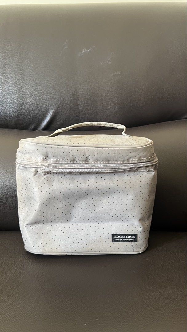 Lock & Lock Insulated Lunch Bag Grey (Category: Tote Bags) located in Taguig. Submitted by xkmanzano078817 (Listing ID 1468414132, Image 1). Description: - Brand: Lock & Lock - Color: Grey with a subtle dot pattern - Insulation: Silver foil interior lining keeps food temperature stable - Storage: Convenient mesh pocket inside the lid for utensils or napkins - Convenience: Sturdy top handle and secure double zipper closure .