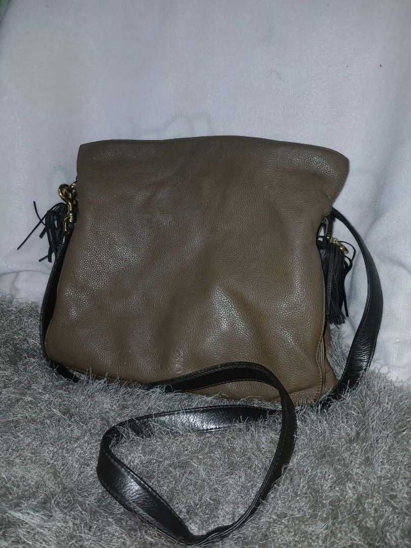 Loewe Flamenco Shoulder Bag (Category: Cross-body Bags) located in Manila. Submitted by chifind_s (Listing ID 1468330522, Image 1). Description: - Material: Premium brown pebbled leather with black leather straps and trim - Hardware: Dark metallic accents - Design: Soft, slouchy silhouette with playful black tassel charms - Closure: Secure top zip closure - Strap: Includes a long, adjustable strap for versatile crossbody or shoulder wear - Condit