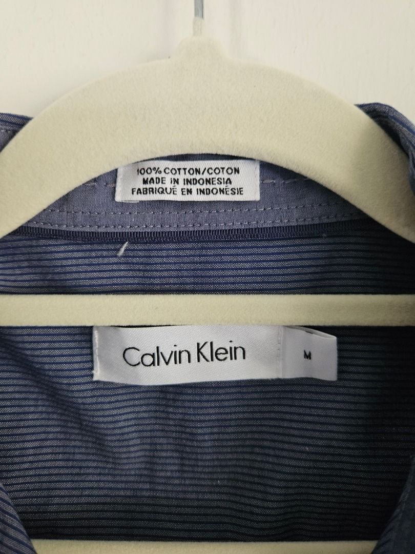 Long Sleeves (Category: Formal Shirts) located in Tanza. Submitted by mama_1996sagi (Listing ID 1468492694, Image 3). Description: - Brand: Calvin Klein - Color/Pattern: Blue with fine stripes - Size: Medium (Standard) - Material: 100% cotton - Condition: Excellent / Clean.