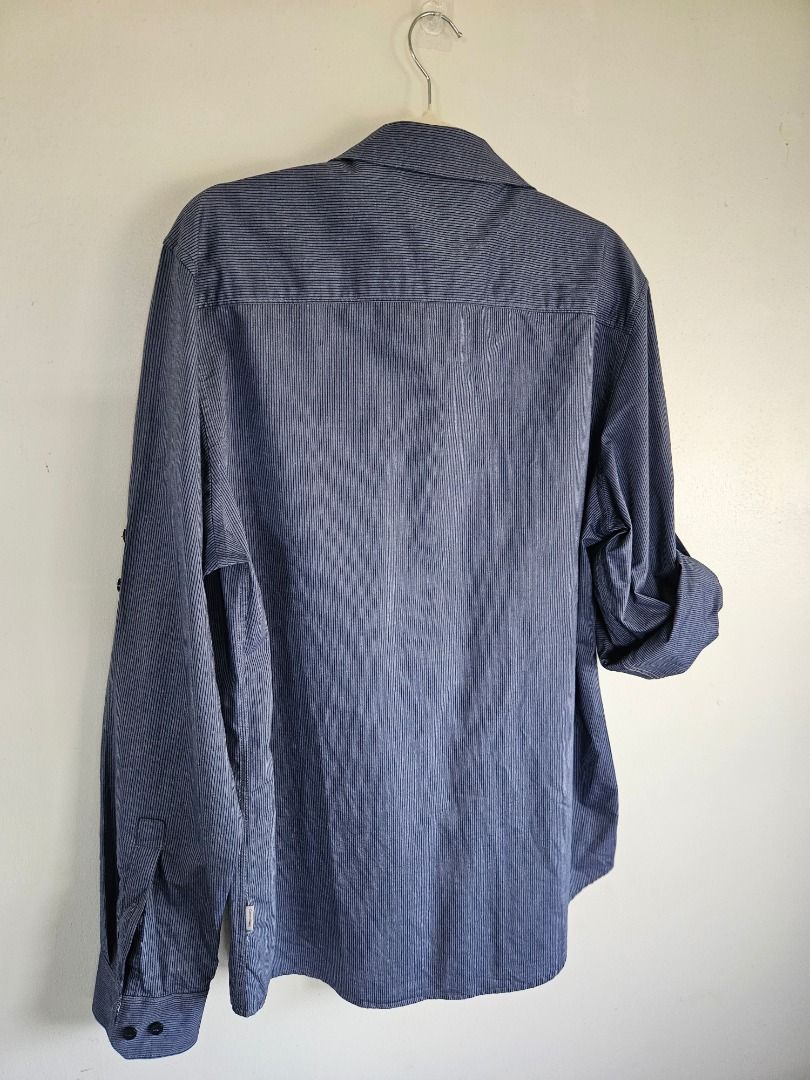 Long Sleeves (Category: Formal Shirts) located in Tanza. Submitted by mama_1996sagi (Listing ID 1468492694, Image 2). Description: - Brand: Calvin Klein - Color/Pattern: Blue with fine stripes - Size: Medium (Standard) - Material: 100% cotton - Condition: Excellent / Clean.