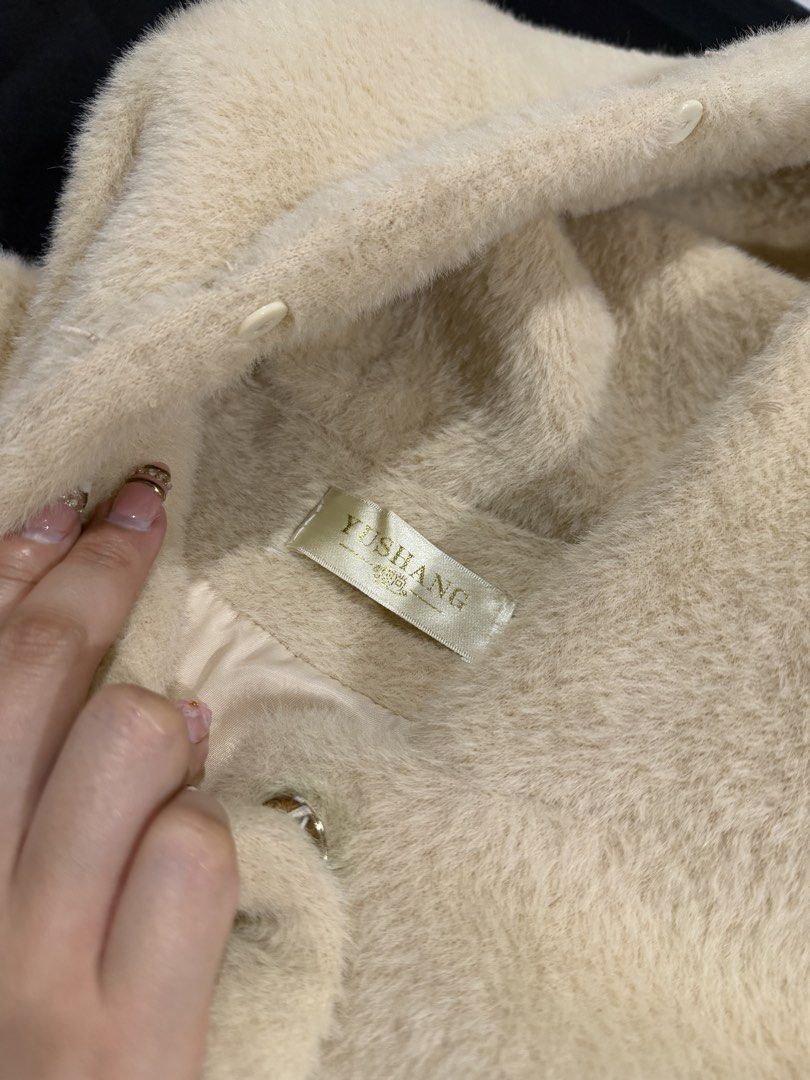 Long Winter Jacket (Category: Coats, Jackets and Outerwear) located in Manila. Submitted by mdncy (Listing ID 1468457972, Image 2). Description: Selling my beige fuzzy hooded coat. * Color: Beige / Cream * Style: Long hooded coat * Material: Soft, fuzzy fabric * Design: Front pockets with decorative details and adjustable hood strings * Condition: Like new * Usage: Used only once during my trip to Vietnam * Reason for selling: Decluttering Still 