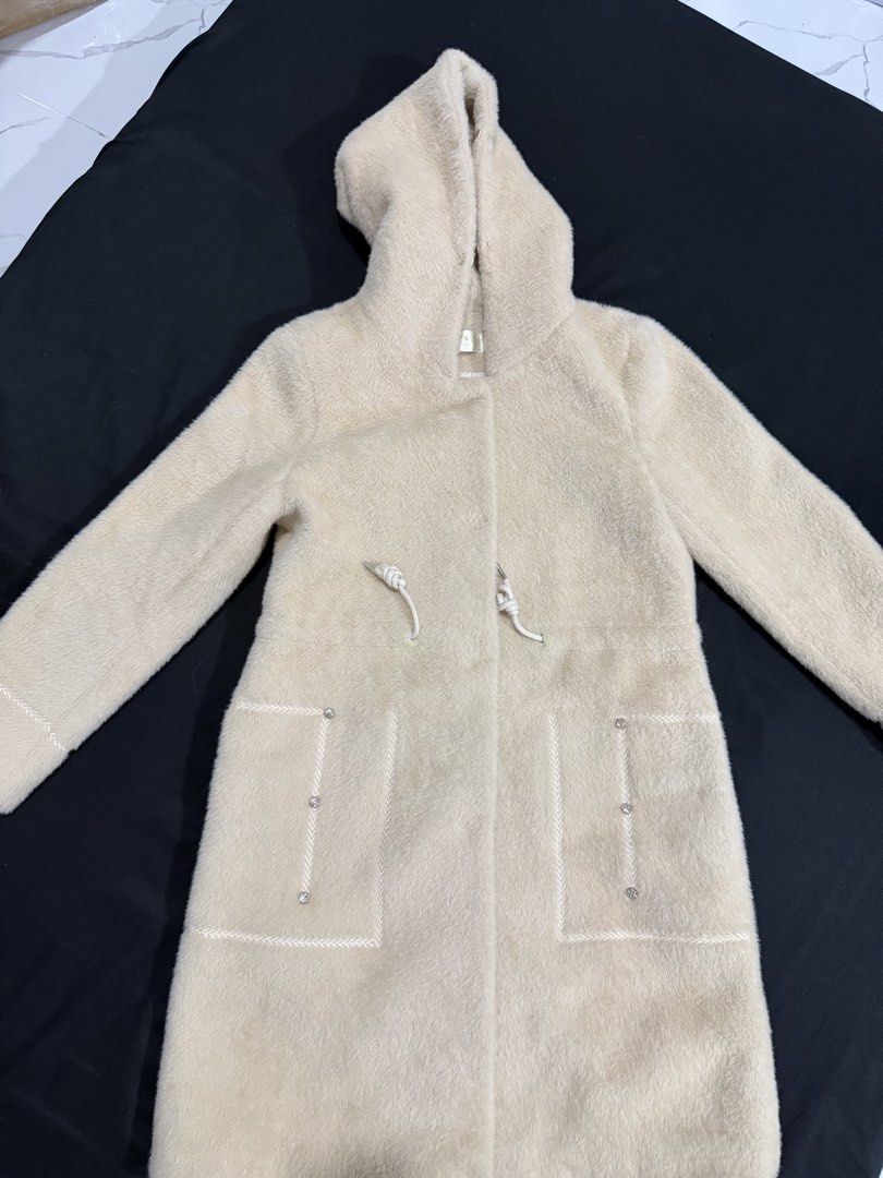 Long Winter Jacket (Category: Coats, Jackets and Outerwear) located in Manila. Submitted by mdncy (Listing ID 1468457972, Image 1). Description: Selling my beige fuzzy hooded coat. * Color: Beige / Cream * Style: Long hooded coat * Material: Soft, fuzzy fabric * Design: Front pockets with decorative details and adjustable hood strings * Condition: Like new * Usage: Used only once during my trip to Vietnam * Reason for selling: Decluttering Still 