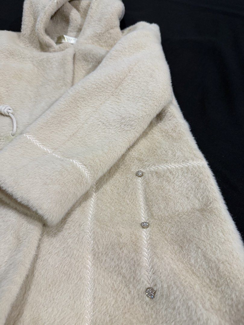Long Winter Jacket (Category: Coats, Jackets and Outerwear) located in Manila. Submitted by mdncy (Listing ID 1468457972, Image 3). Description: Selling my beige fuzzy hooded coat. * Color: Beige / Cream * Style: Long hooded coat * Material: Soft, fuzzy fabric * Design: Front pockets with decorative details and adjustable hood strings * Condition: Like new * Usage: Used only once during my trip to Vietnam * Reason for selling: Decluttering Still 