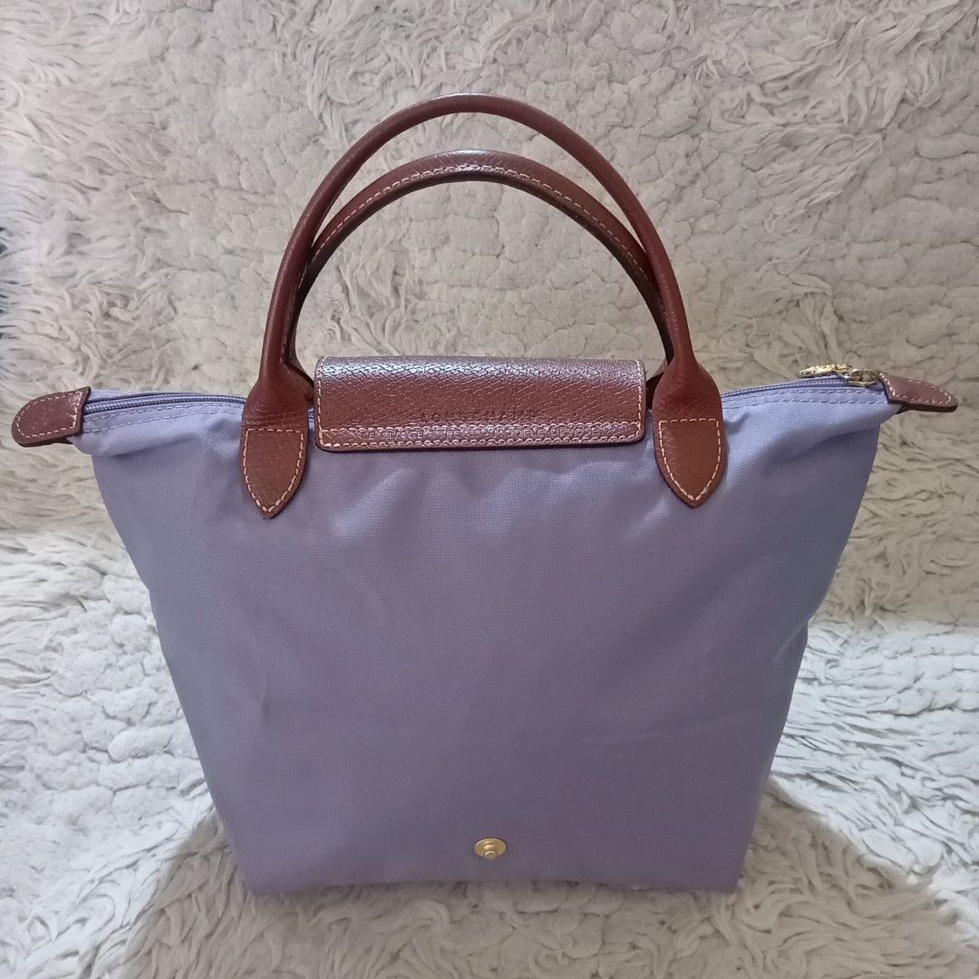 Longchamp Le Pliage Lilac Tote Bag (Category: Luxury Bags & Wallets) located in Baguio. Submitted by sheren_signatures (Listing ID 1468288131, Image 2). Description: - Brand: Longchamp Le Pliage - Size: Small handle bag - Color: Pastel lilac with brown leather trim - Hardware: Gold-tone snap button and zipper pull with rider logo - Material: Durable foldable nylon body - Interior: Beige lining with a small slip pocket and white tag - Condition: C
