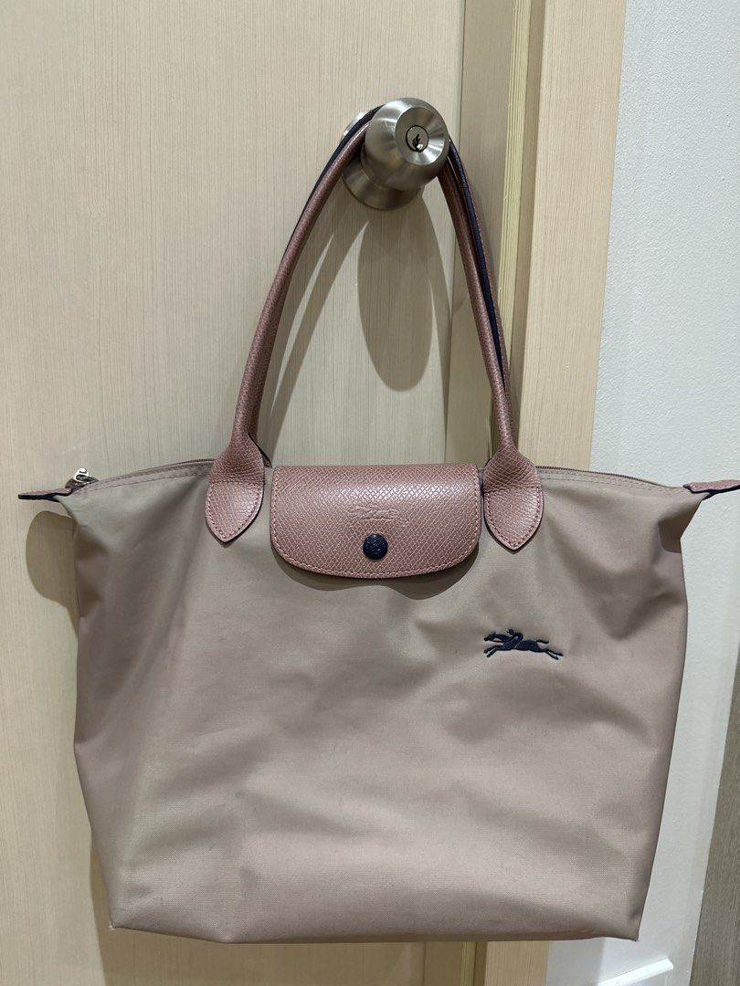 Longchamp Le Pliage Nylon Tote Bag (Category: Luxury Bags & Wallets) located in Quezon City. Submitted by wildhawk_77eaf5 (Listing ID 1468374348, Image 1). Description: - Brand/Model: Longchamp Tote Bag - Color: pink nylon with pink leather handles and flap - Details: Dark navy blue embroidered horse logo and silver-tone hardware - Closure: Zipper and snap button - Comfort: Long shoulder straps for easy carrying - Interior: Spacious for all daily