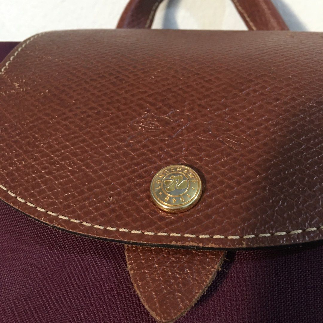 Longchamp Le Pliage Plum Nylon Backpack (Category: Backpacks) located in Mandaluyong City. Submitted by cjdp17 (Listing ID 1468362476, Image 2). Description: - Brand: Longchamp - Color: Plum purple with brown leather flap and handles - Material: Durable lightweight nylon and leather - Closure: Zip-top with snap button flap - Features: Adjustable woven straps, top handle, foldable design - Condition: Great size for daily commuting, school, or trav