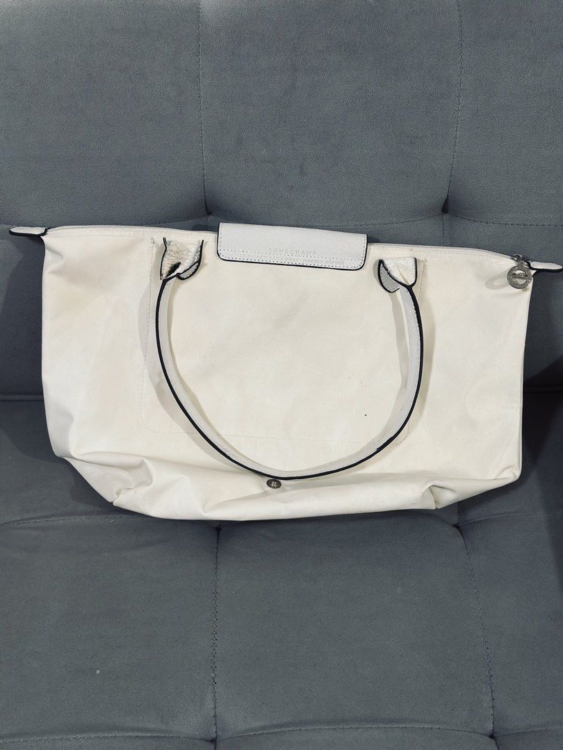 Longchamp Le Pliage White Tote Bag (Category: Luxury Bags & Wallets) located in Tarlac. Submitted by via_banana (Listing ID 1468409670, Image 2). Description: - Color: Classic White - Material: Durable nylon with leather handles and black edge detailing - Closure: Secure top zipper with snap flap - Details: Iconic embroidered horse logo on the front - Features: Spacious interior, lightweight, and foldable design - Best For: Daily essentials, scho