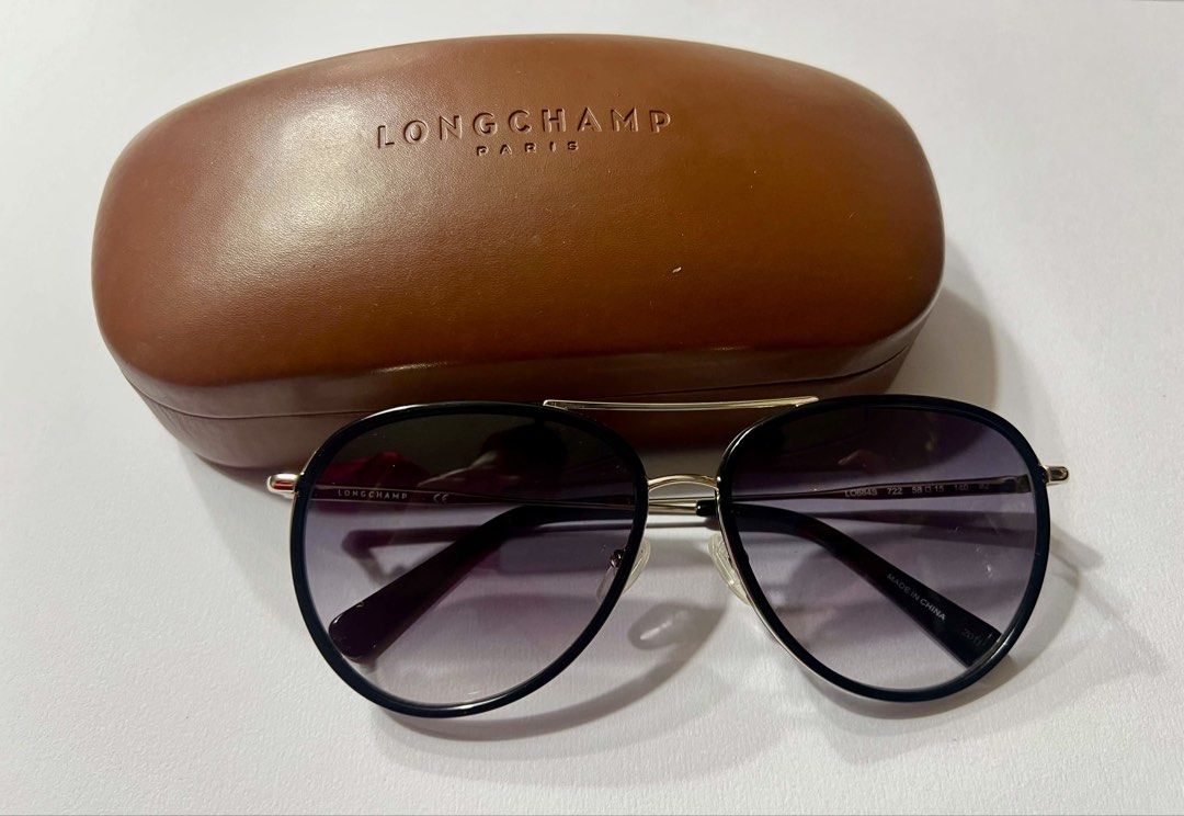 Longchamp LO684S Aviator Sunglasses with Case (Category: Sunglasses & Eyewear) located in Mandaluyong City. Submitted by kaycee_0821 (Listing ID 1468429129, Image 1). Description: - Brand: Longchamp - Model: LO684S (Color 722) - Style: Aviator sunglasses with gradient tinted lenses - Frame: Metal with sleek black trim details - Size: 58-15-140 - Origin: Made in China - Condition: Great overall condition - Inclusions: Original brown hard leather c