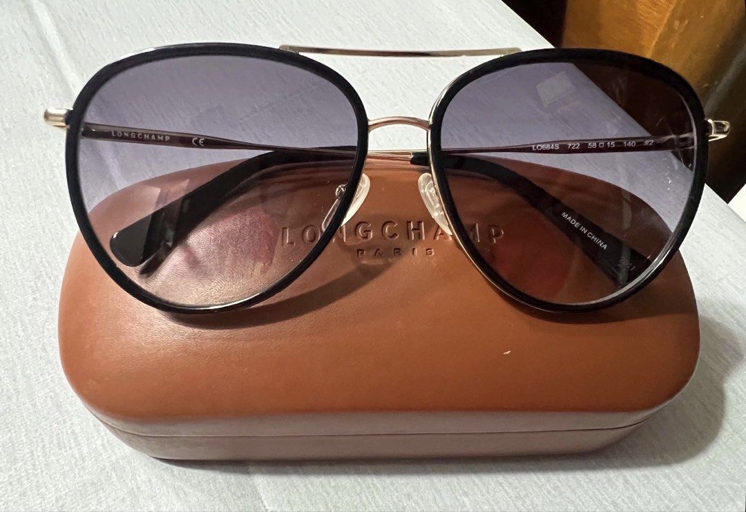 Longchamp LO684S Aviator Sunglasses with Case (Category: Sunglasses & Eyewear) located in Mandaluyong City. Submitted by kaycee_0821 (Listing ID 1468429129, Image 2). Description: - Brand: Longchamp - Model: LO684S (Color 722) - Style: Aviator sunglasses with gradient tinted lenses - Frame: Metal with sleek black trim details - Size: 58-15-140 - Origin: Made in China - Condition: Great overall condition - Inclusions: Original brown hard leather c