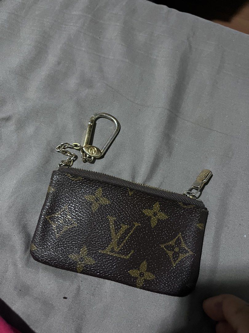 Louis Vuitton Monogram Key Pouch coin pouch (Category: Luxury Bags & Wallets) located in Manila. Submitted by madecuratedwithlove11 (Listing ID 1468460718, Image 3). Description: - Louis Vuitton monogram canvas coin purse and key holder - Classic brown exterior with iconic LV monogram pattern - Gold-tone hardware with attached chain and hook - Secure zip top closure - Interior stamped Louis Vuitton Paris made in France - Compact size fits easily 