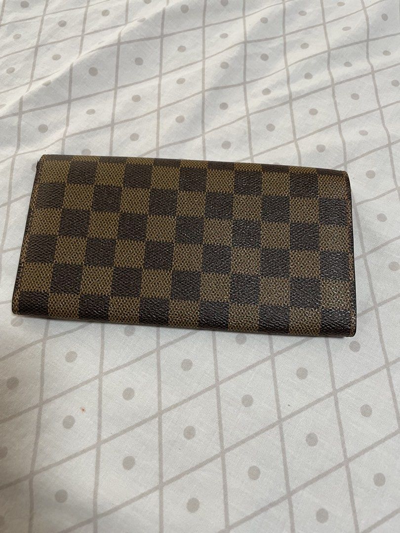 Louis Vuitton Damier Ebene Long Wallet (Category: Luxury Bags & Wallets) located in Quezon City. Submitted by tor_ash (Listing ID 1468322710, Image 2). Description: - Brand: Louis Vuitton - Style: Long Wallet / Clutch - Material/Design: Classic Damier Ebene canvas with brown checkered pattern - Hardware: Gold-tone snap button closure - Interior: Multiple card slots and spacious compartments - Details: Stamped Louis Vuitton Paris inside, clean sti