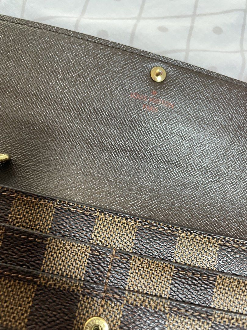Louis Vuitton Damier Ebene Long Wallet (Category: Luxury Bags & Wallets) located in Quezon City. Submitted by tor_ash (Listing ID 1468322710, Image 3). Description: - Brand: Louis Vuitton - Style: Long Wallet / Clutch - Material/Design: Classic Damier Ebene canvas with brown checkered pattern - Hardware: Gold-tone snap button closure - Interior: Multiple card slots and spacious compartments - Details: Stamped Louis Vuitton Paris inside, clean sti