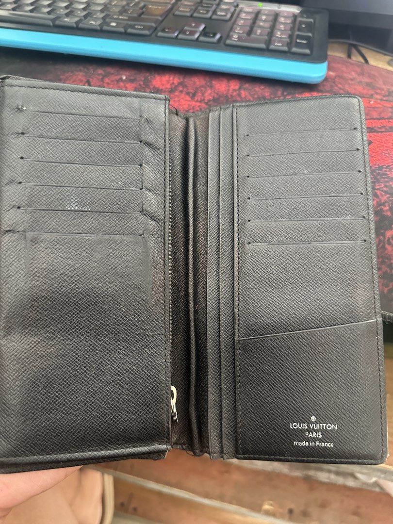Louis Vuitton Damier Graphite Brazza Wallet (Category: Luxury Bags & Wallets) located in Bustos. Submitted by theprelovedshopbulacan (Listing ID 1468349227, Image 2). Description: - Brand: Louis Vuitton - Model: Brazza Wallet - Material: Iconic Damier Graphite canvas with black crossgrain leather interior - Features: Multiple card slots, spacious compartments, and a secure zipped coin pocket - Origin: Made in France (Date code stamped inside pock