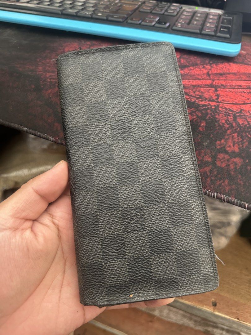 Louis Vuitton Damier Graphite Brazza Wallet (Category: Luxury Bags & Wallets) located in Bustos. Submitted by theprelovedshopbulacan (Listing ID 1468349227, Image 1). Description: - Brand: Louis Vuitton - Model: Brazza Wallet - Material: Iconic Damier Graphite canvas with black crossgrain leather interior - Features: Multiple card slots, spacious compartments, and a secure zipped coin pocket - Origin: Made in France (Date code stamped inside pock