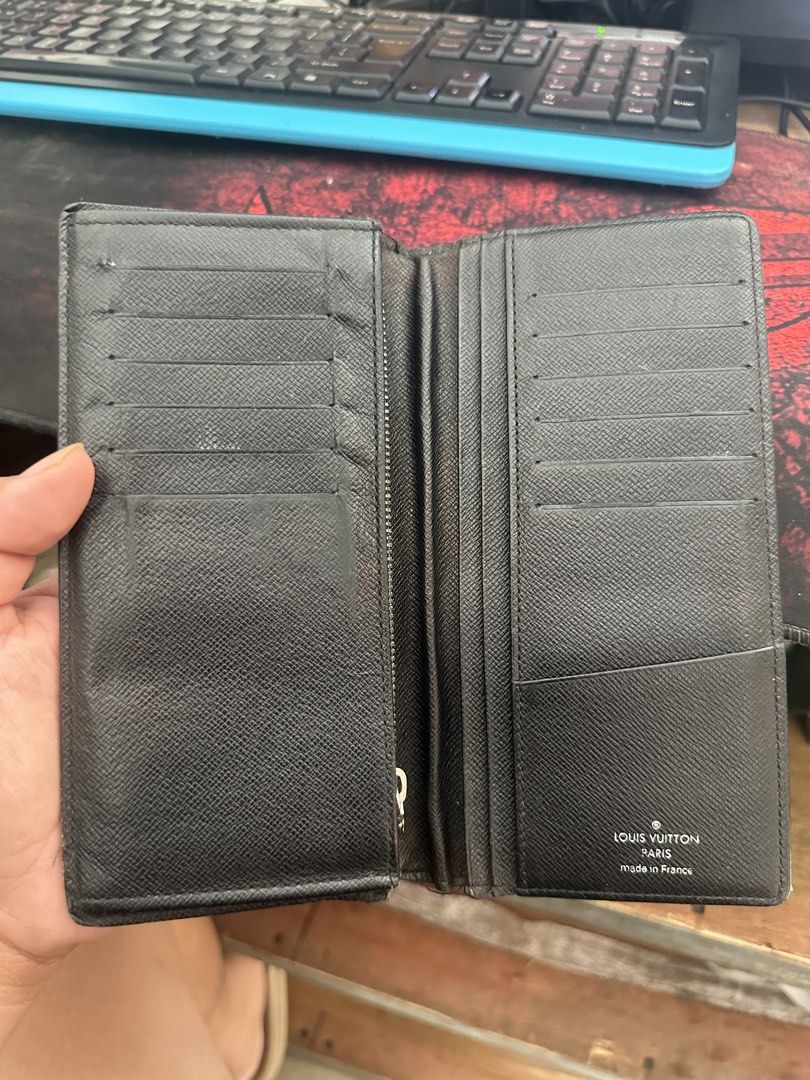 Louis Vuitton Damier Graphite Brazza Wallet (Category: Luxury Bags & Wallets) located in Bustos. Submitted by theprelovedshopbulacan (Listing ID 1468349227, Image 3). Description: - Brand: Louis Vuitton - Model: Brazza Wallet - Material: Iconic Damier Graphite canvas with black crossgrain leather interior - Features: Multiple card slots, spacious compartments, and a secure zipped coin pocket - Origin: Made in France (Date code stamped inside pock