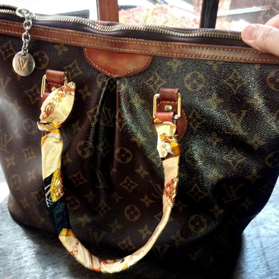 Louis Vuitton Monogram Canvas Tote Handbag (Category: Tote Bags) located in Manila. Submitted by lene48 (Listing ID 1468306384, Image 2). Description: - Classic brown monogram canvas tote with signature LV pattern - Cowhide leather trim showing a gorgeous, rich patina from being well-loved - Secure top zip closure with a hanging silver-tone LV charm - Dual top handles elegantly wrapped with twilly scarves - Spacious interior fabric lining with mu