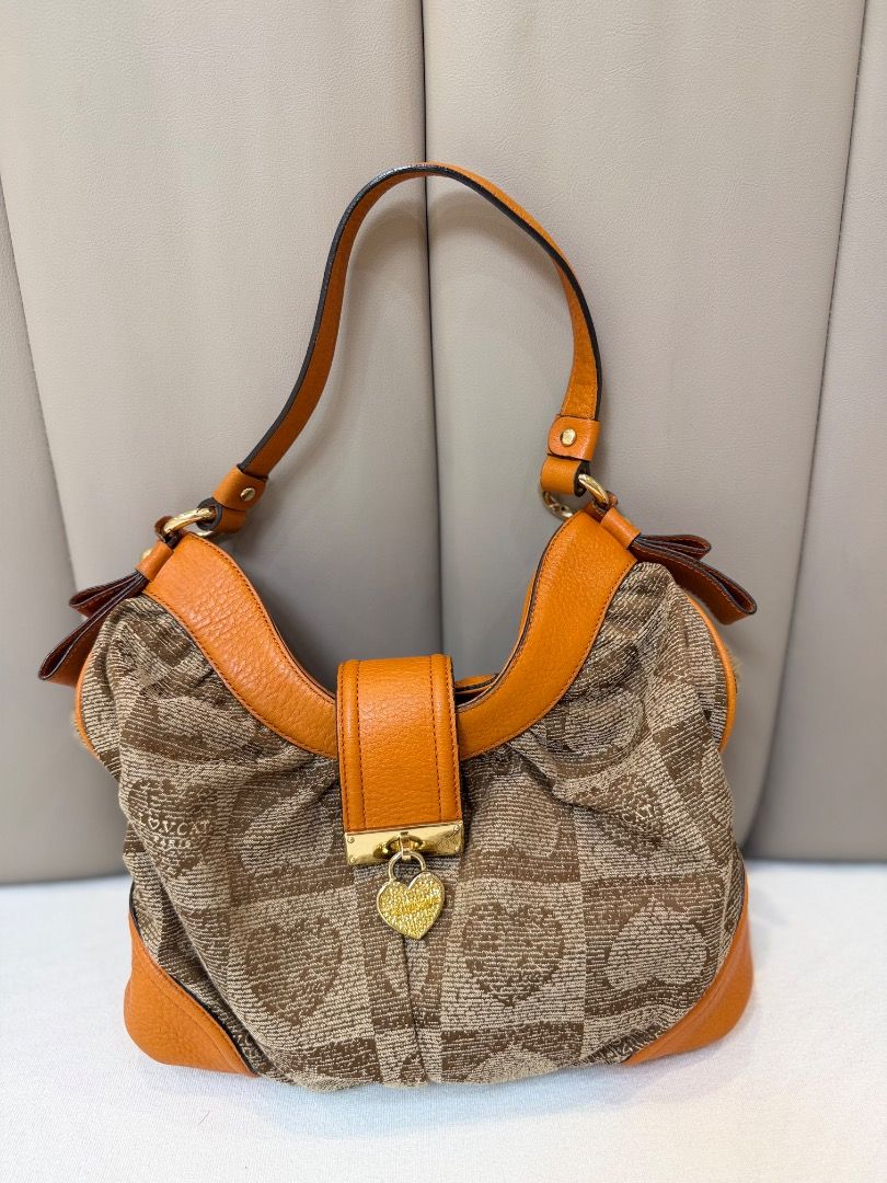 LOVCAT Paris Brown Orange Heart Pattern Shoulder Bag (Category: Shoulder Bags) located in Rizal. Submitted by je_resada (Listing ID 1468433001, Image 1). Description: - Authentic LOVCAT Paris shoulder bag - Brown fabric featuring a chic heart geometric pattern - Vibrant orange leather trim and adjustable strap - Elegant gold-tone hardware with clasp closure and hanging heart padlock charm - Structured base equipped with metal protective feet - Ro