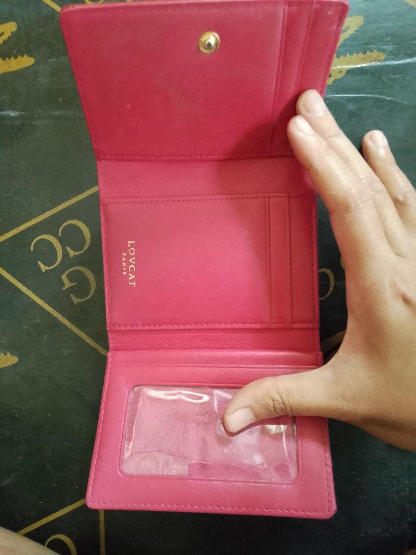 Lovcat Red Leather Tri-fold Wallet with Rhinestone Clasp (Category: Wallets & Card holders) located in Manila. Submitted by amiarnajea96023 (Listing ID 1468327846, Image 3). Description: - Brand/Model: Authentic Lovcat Paris tri-fold wallet - Color & Material: Vibrant red leather with gold-tone hardware - Special Details: Eye-catching rhinestone circle clasp with a center heart detail - Interior Layout: Multiple card slots, clear ID window, and s