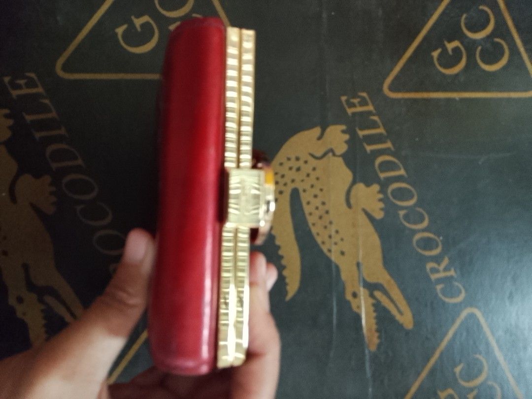 Lovcat Red Leather Tri-fold Wallet with Rhinestone Clasp (Category: Wallets & Card holders) located in Manila. Submitted by amiarnajea96023 (Listing ID 1468327846, Image 2). Description: - Brand/Model: Authentic Lovcat Paris tri-fold wallet - Color & Material: Vibrant red leather with gold-tone hardware - Special Details: Eye-catching rhinestone circle clasp with a center heart detail - Interior Layout: Multiple card slots, clear ID window, and s