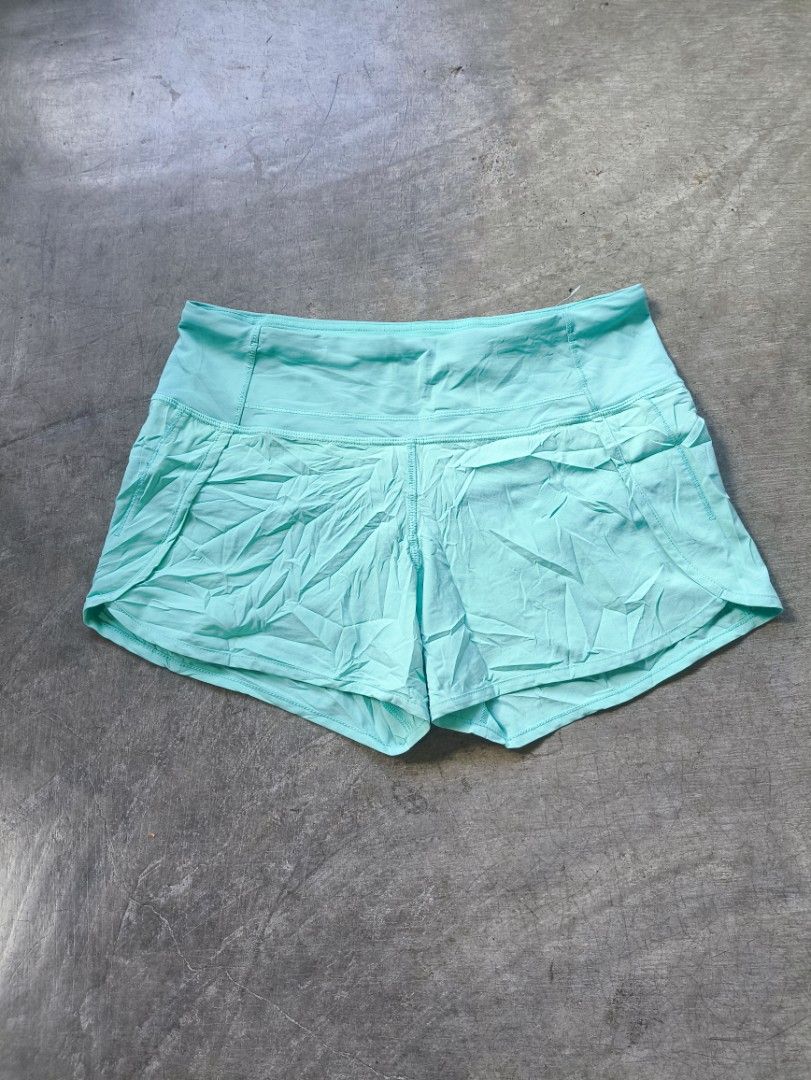 Lululemon Athletic Shorts Size 4 Aqua Blue (Category: Shorts) located in Manila. Submitted by maryaganda (Listing ID 1468354547, Image 2). Description: - Brand: Lululemon - Color: Bright aqua blue - Size: 4 - Features: Secure back waistband zipper pocket for keys/cards, built-in liner, lightweight fabric - Detail: Signature silver reflective logo on the leg - Condition: Brand new with fabric care and size tags attached.