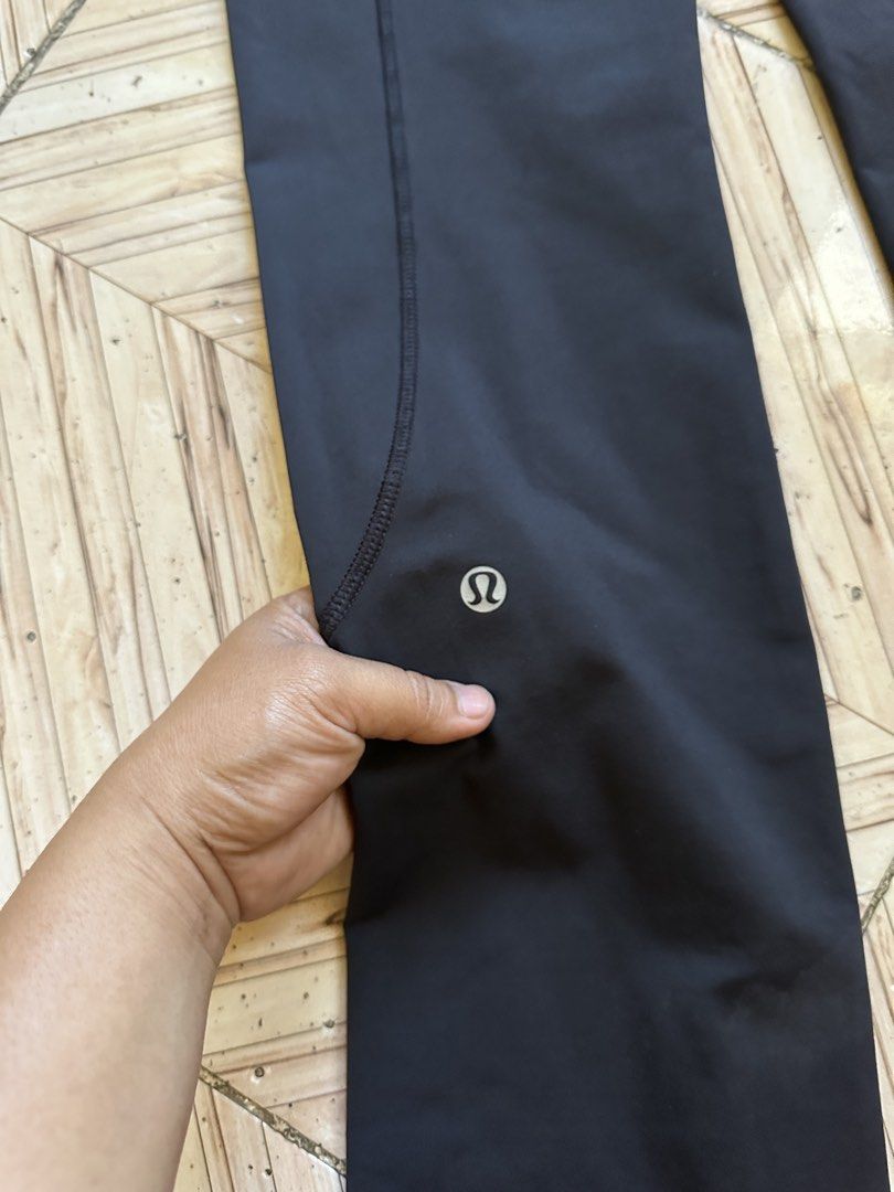 Lululemon Black Athletic Pants Leggings Size 6 (Category: Activewear) located in Angeles City. Submitted by alejeong27 (Listing ID 1468336213, Image 3). Description: - Brand: Lululemon - Size: 6 - Color: Black with blue and white patterned waistband - Pockets: Convenient side pockets and a secure zippered back pocket - Safety: Reflective details on the side seams for low-light visibility - Details: Signature silver Lululemon logo stamped on the l