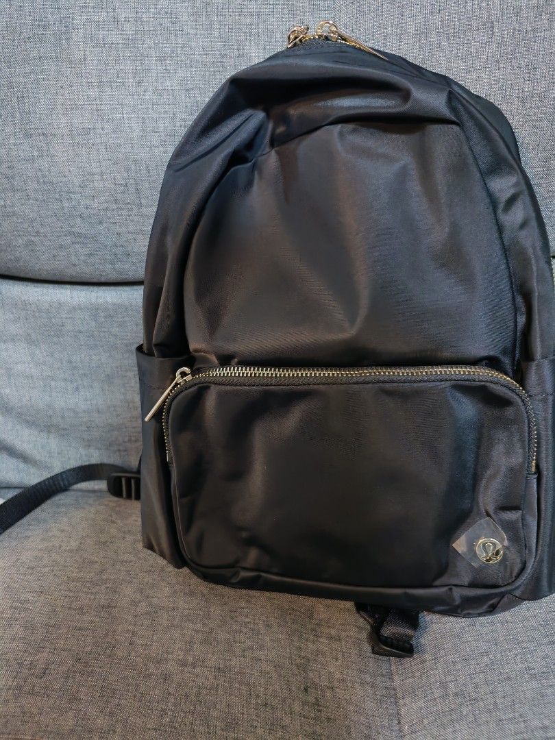 Lululemon Black Backpack with Gold Zippers (Category: Backpacks) located in Makati City. Submitted by momsieapril (Listing ID 1468354476, Image 1). Description: - Brand: Lululemon - Color: Black with chic gold-toned hardware - Material: Durable, high-quality nylon - Storage: Spacious main compartment, front zippered pocket, and side slip pockets - Details: Iconic logo badge on the front, brand-engraved zipper pulls, and adjustable shoulder straps