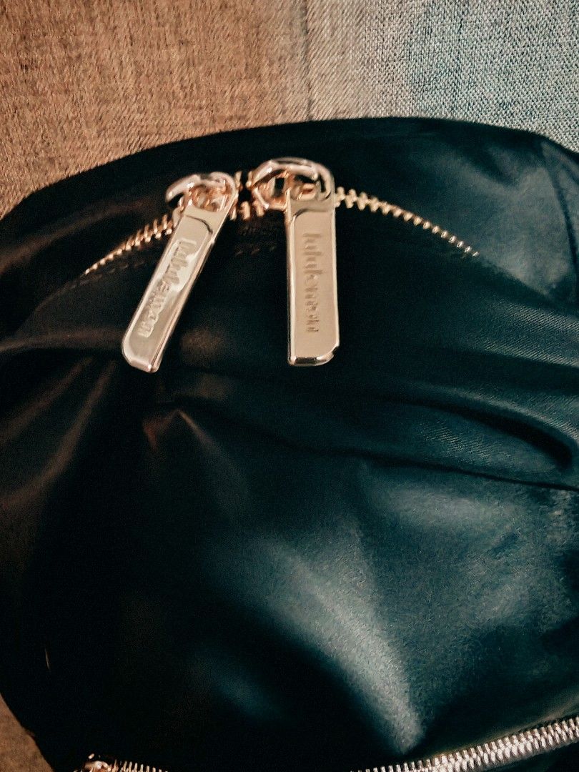 Lululemon Black Backpack with Gold Zippers (Category: Backpacks) located in Makati City. Submitted by momsieapril (Listing ID 1468354476, Image 3). Description: - Brand: Lululemon - Color: Black with chic gold-toned hardware - Material: Durable, high-quality nylon - Storage: Spacious main compartment, front zippered pocket, and side slip pockets - Details: Iconic logo badge on the front, brand-engraved zipper pulls, and adjustable shoulder straps