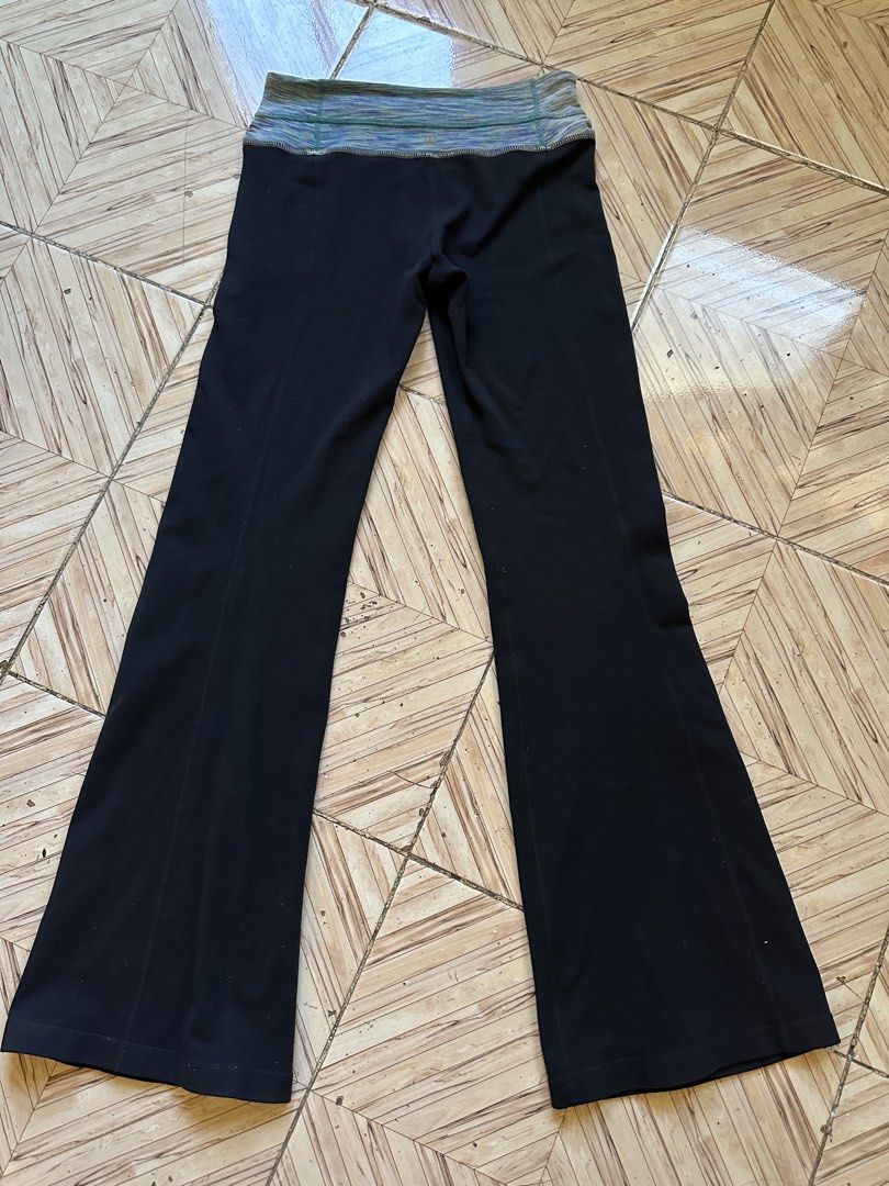 Lululemon Black Flare Yoga Pants Size 4 (Category: Activewear) located in Angeles City. Submitted by alejeong27 (Listing ID 1468335604, Image 2). Description: - Brand: Lululemon - Color: Black with blue, green, and purple patterned waistband - Size: 4 (verified via size dot in hidden pocket) - Style: Classic flared leg with foldover waist design - Condition: Great activewear staple for workouts or casual everyday wear.