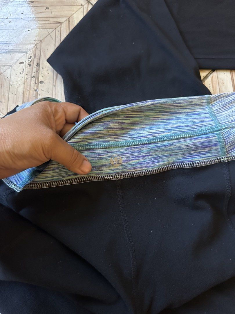 Lululemon Black Flare Yoga Pants Size 4 (Category: Activewear) located in Angeles City. Submitted by alejeong27 (Listing ID 1468335604, Image 3). Description: - Brand: Lululemon - Color: Black with blue, green, and purple patterned waistband - Size: 4 (verified via size dot in hidden pocket) - Style: Classic flared leg with foldover waist design - Condition: Great activewear staple for workouts or casual everyday wear.